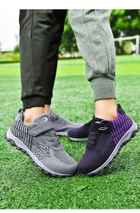 Breathable fly-knit walking shoes for men and women shown on a green grass field