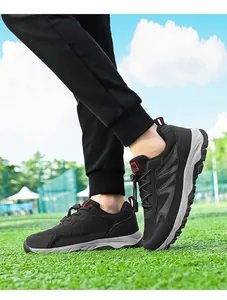 Macro view of black mesh outdoor walking shoes featuring a quick-lace toggle closure system.
