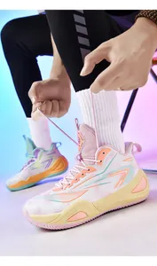 Close-up view of stylish mismatched 906 basketball shoes being laced up against neon background