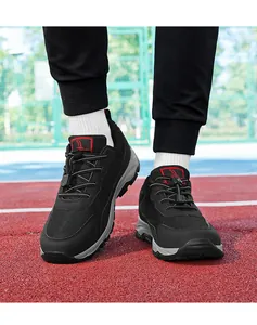 Close-up detail view of breathable black mesh walking shoes on an outdoor track