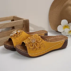 Yellow women's platform wedge sandals featuring a large 3D flower and hollow stitch detail