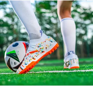 Professional knit soccer shoes with vibrant colorful prints and orange TF turf soles