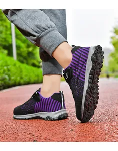 Purple knit walking shoes for men and women on outdoor track, lightweight and breathable.