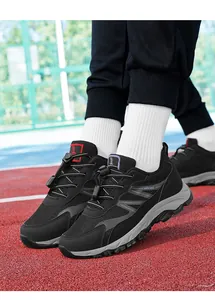 Close-up of breathable black mesh walking shoes featuring adjustable lacing and durable soles.