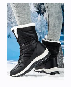 Macro view of waterproof black snow boots with thick faux fur lining in snowy scene