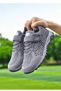 Close-up detail of grey breathable fly-knit walking shoes with velcro strap