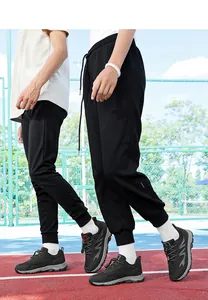 Close-up of black breathable mesh walking shoes on a running track