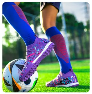 Detailed macro view of purple knitted TF soccer shoes with patterns on turf field