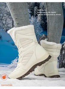 Detail view of off-white high-top winter snow boots with plush faux fur lining.