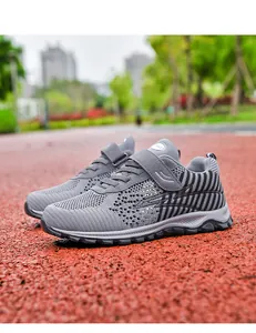 Detailed view of grey mesh breathable walking shoes with velcro strap on outdoor track