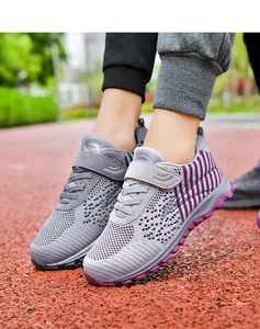 Close-up detail of breathable grey and purple knitted walking shoes with velcro strap