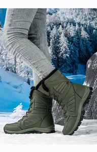 Waterproof olive green women's snow boots in a scenic winter forest setting.