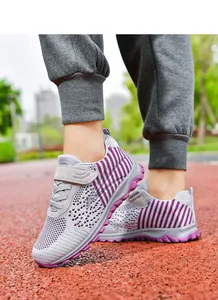 Detail of breathable purple knit walking shoes with mesh upper and velcro strap