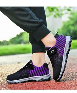 Macro view of black and purple flying woven sneakers showing breathable mesh and sole
