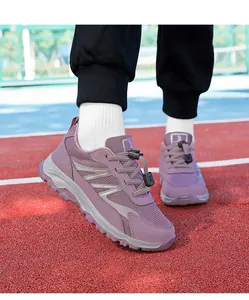 Side view of mauve mesh walking shoes shown on a running track during outdoor activity
