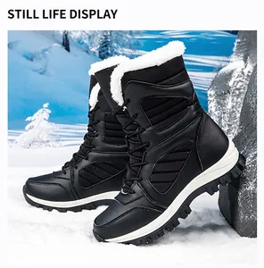 Black waterproof snow boots with plush white fur lining shown in a snowy outdoor landscape