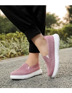 Lightweight pink mesh slip-on walking shoes with breathable knit texture detail.