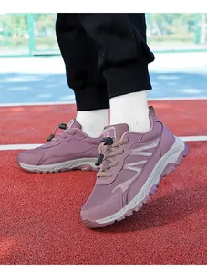 Close-up detail of purple mesh walking shoes featuring quick-lace system on red track