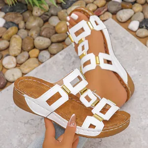 Stylish women's white platform sandals with gold buckles and peep-toe wedge design