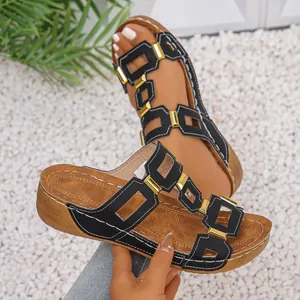 Women's black wedge sandals with hollow straps and gold buckles for summer fashion.