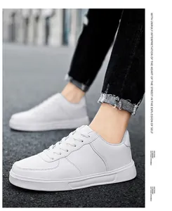 Detailed view of white low-top casual sneakers worn outdoors for street style