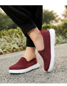 Close-up of wine red breathable mesh slip-on walking shoes for men and women on street