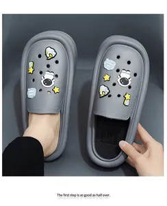 Detailed top view of grey EVA platform clogs with cute cartoon astronaut charms.