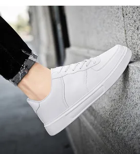 Macro detail showing side view of white classic low-top casual board sneakers with laces