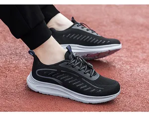 Detailed view of breathable black flyknit walking shoes worn on a red sports track