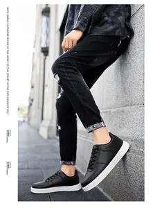 Close-up of black low-top leather sneakers on a street fashion model