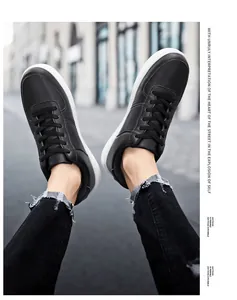 First-person view of black retro low-top skate sneakers worn with distressed black jeans.
