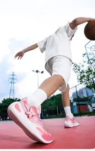 Detailed macro view of pink and white low-top basketball shoes during outdoor court action