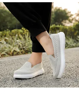 Breathable light grey mesh slip-on walking shoes shown in outdoor lifestyle setting