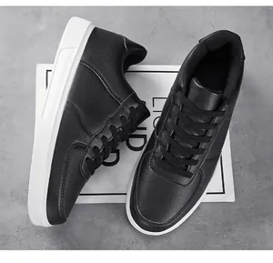 Overhead view of black low-top skate shoes with white flat soles and textured leather