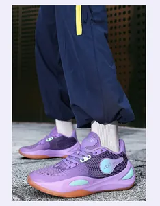 Detailed view of purple low-top basketball shoes with glowing accents and mesh upper