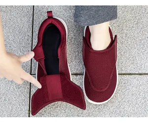 Primo piano di scarpe da camminata bordeaux con ampia chiusura in velcro per anziani.