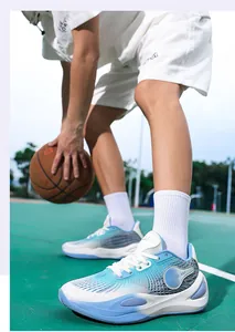 Detail shot of blue gradient low-top basketball shoes on a green outdoor sports court