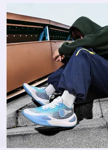 Low-top blue and white gradient basketball shoes with non-slip sole in lifestyle setting