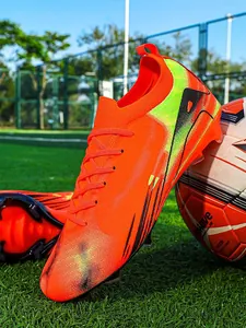 Vibrant orange and lime green low-top soccer cleats for professional competition and training