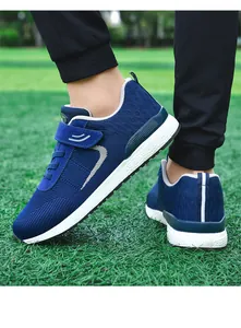 Close-up detail of blue fly-knit walking shoes with breathable mesh and velcro strap.