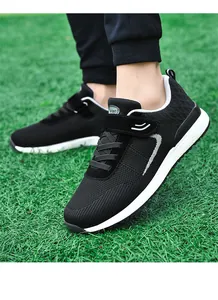 Side view detail of black breathable flying woven walking shoes with adjustable velcro strap