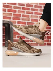 Detail view of breathable men's running sneakers with brown knit upper and stylish sole.