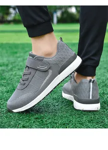 Grey breathable mesh walking shoes for men and women featuring a secure velcro strap detail