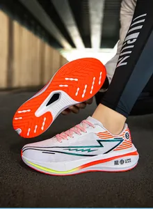Detailed view of breathable running shoes featuring a vibrant orange non-slip sole