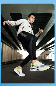 Action shot of breathable mesh running shoes with neon green accents on a male model.