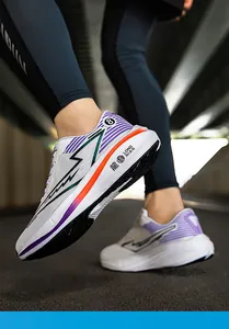 Dynamic action shot of white and purple breathable mesh running sneakers for sports