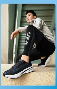 Side view of breathable black mesh running shoes featuring thick white cushioned soles