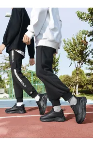 Detail of black leather walking shoes for seniors worn on a professional athletic track