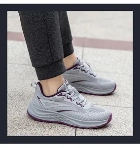 Detailed view of breathable grey flyknit mesh running shoes with purple accents