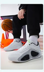 Detail shot of white breathable low-top mesh basketball shoes for training and sports.